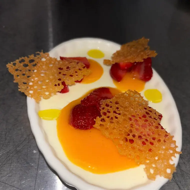 Panna cotta with mango coulis and fresh strawberries