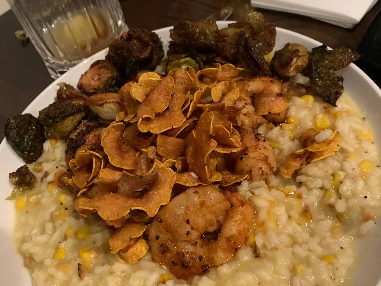 Shrimp risotto with sweet corn, crispy Brussels sprouts and sweet-potato crisps.