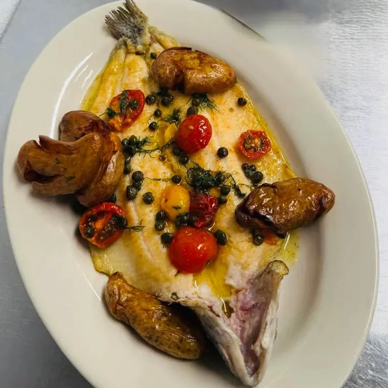 The Forest Edge Trout — whole pan-seared trout with capers, blistered cherry tomatoes, dill and fingerling potatoes